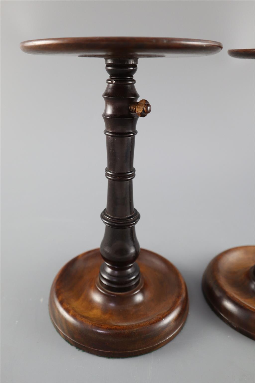 A pair of George III mahogany and ebony adjustable candle stands, height 8.75in.